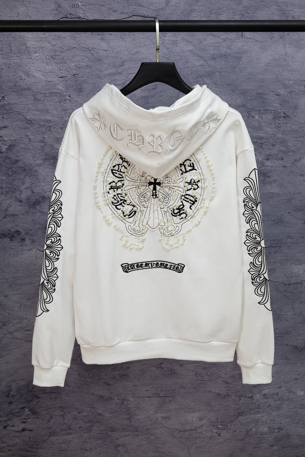 White long-sleeve zip hoodie with back crest graphic and patterned sleeve details