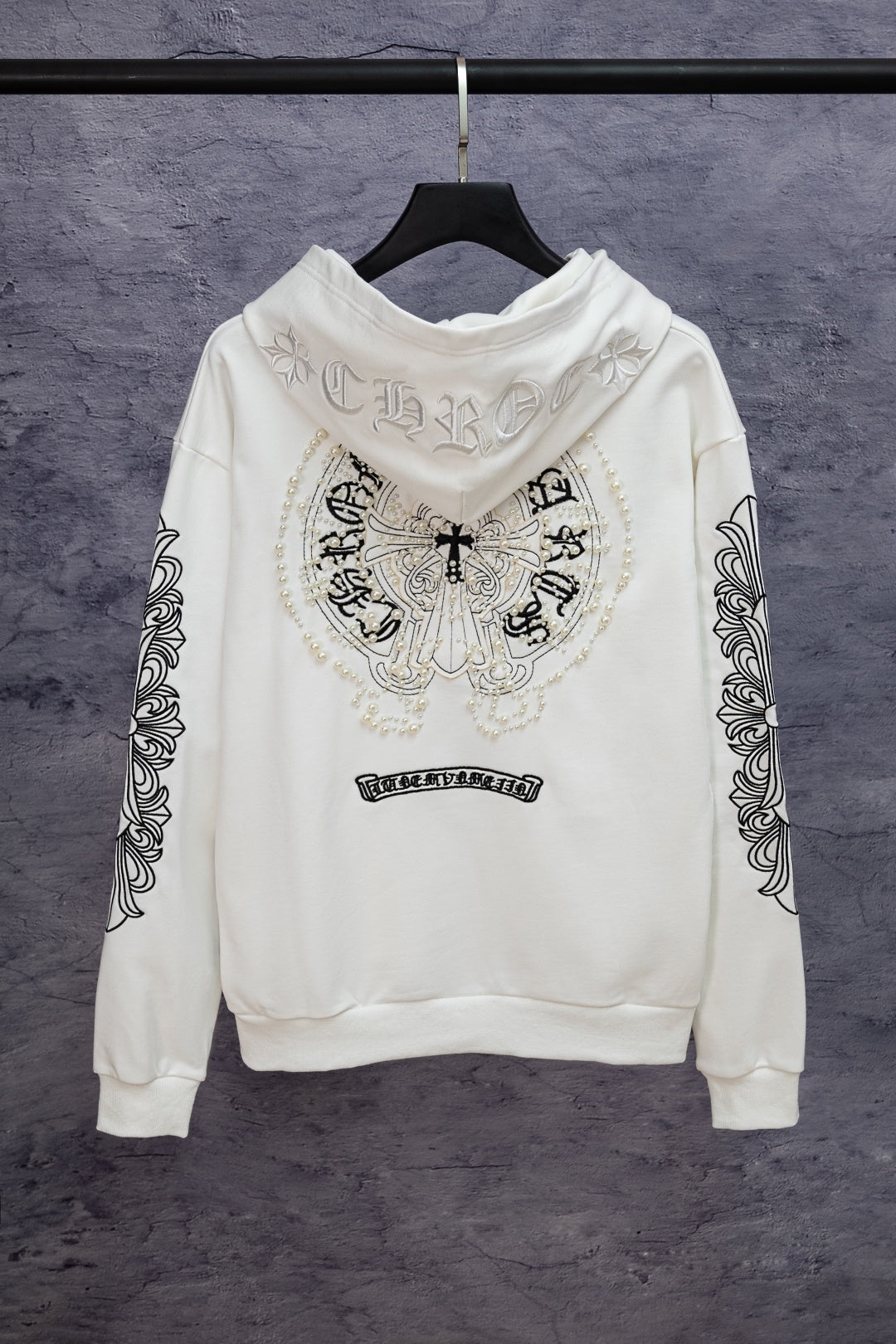 White long-sleeve zip hoodie with back crest graphic and patterned sleeve details