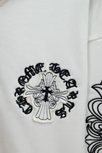 White hoodie sleeve graphic with cross illustration and ornate black lettering