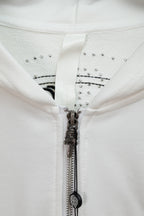 White hoodie zipper placket with studded rhinestone trim and metal zipper pull