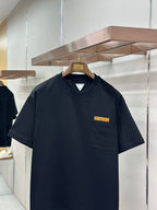 Navy crewneck pocket T-shirt with small yellow logo patch