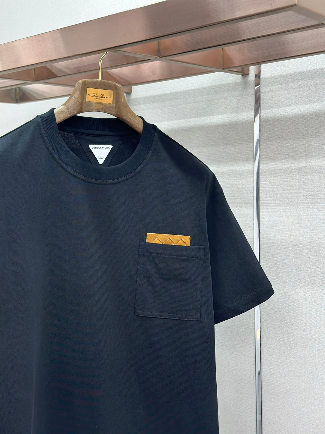 Navy T-shirt with front pocket and yellow logo patch
