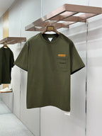 Olive green crew-neck T-shirt with chest pocket and rectangular logo patch
