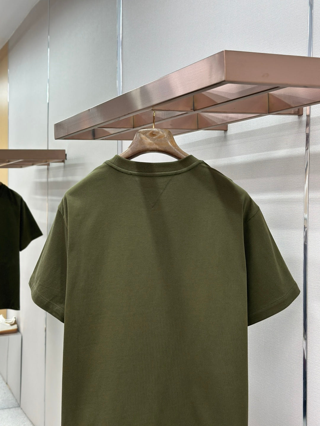 Olive green crew-neck T-shirt, back view with plain rear panel