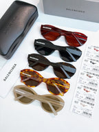 Sunglasses assortment with red, black, tortoise, and beige frames and tinted lenses.