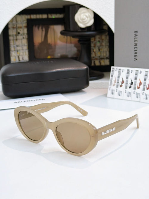 Light beige round sunglasses with tinted lenses and full-rim frame.