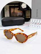 Amber tortoise round sunglasses with tinted lenses and full-rim frame.