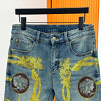 Light blue Versace jeans with gold baroque medallion and crest prints, waist close-up