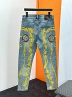 Light blue Versace jeans with gold baroque medallion ornament print, hanging on rack