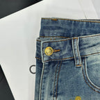 Blue denim jeans waistband with gold button and belt loops, front view close-up.