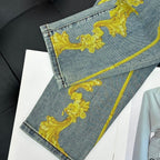 Versace blue denim jeans side leg with yellow floral scroll motif