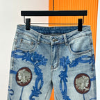 Versace light-wash denim jeans with button fly and blue baroque print