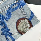 Denim jeans detail: blue baroque motif with round lion medallion