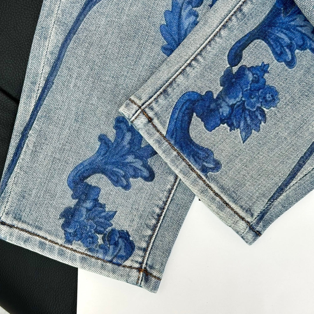Denim jeans hem detail with blue baroque print and stitched pocket edge