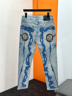 Versace light-wash denim jeans on display, blue baroque scrolls with lion medallions