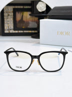 Black full-rim eyeglasses with Dior logo on lenses and thin metal hinges