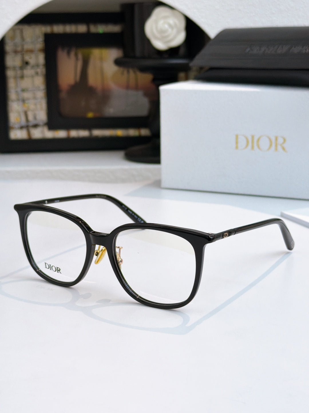 Black full-rim eyeglasses with clear lenses, front angled view, Dior logo