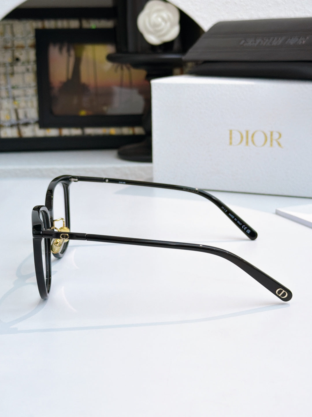 Black full-rim eyeglasses with metal hinges and curved temple, Dior logo