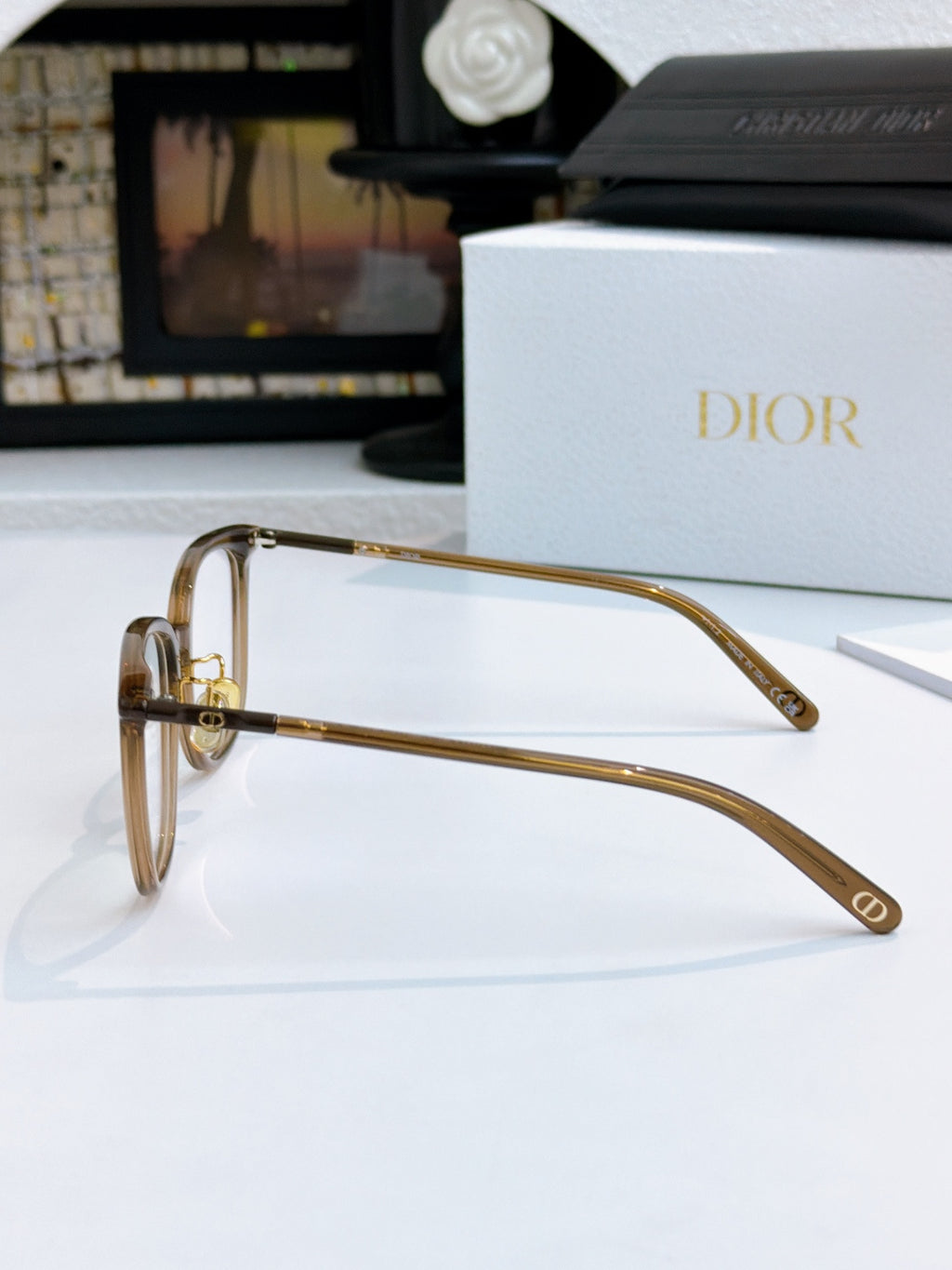 Gold-toned full-rim eyeglasses with metal hinges and Dior logo on temple