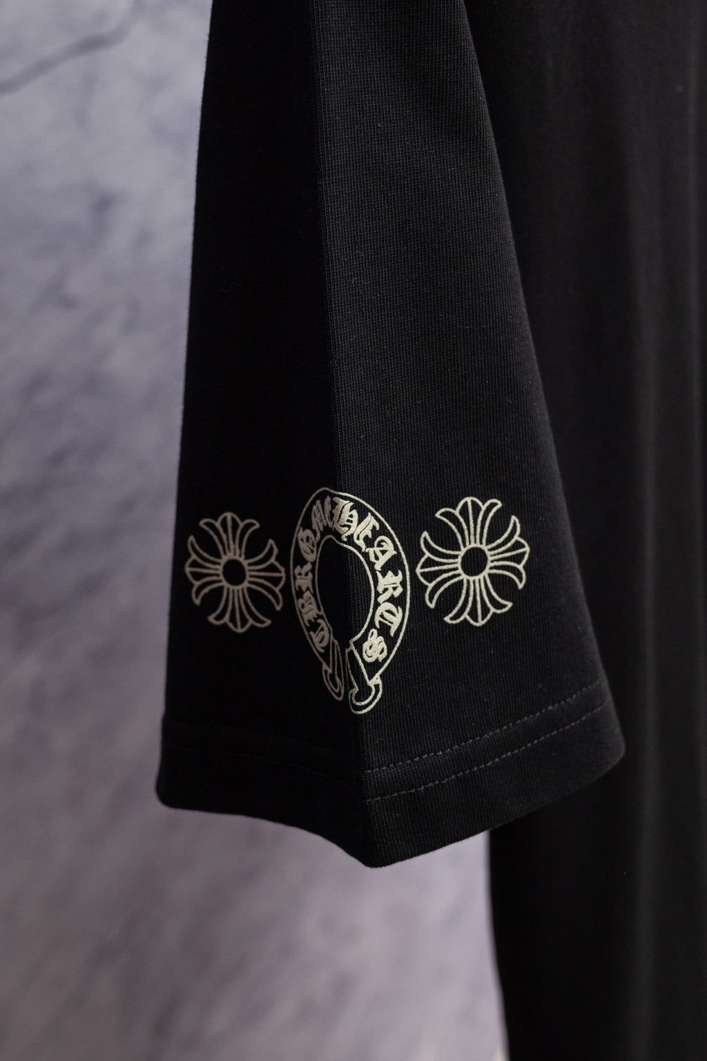 Black T-shirt sleeve with white floral graphic print