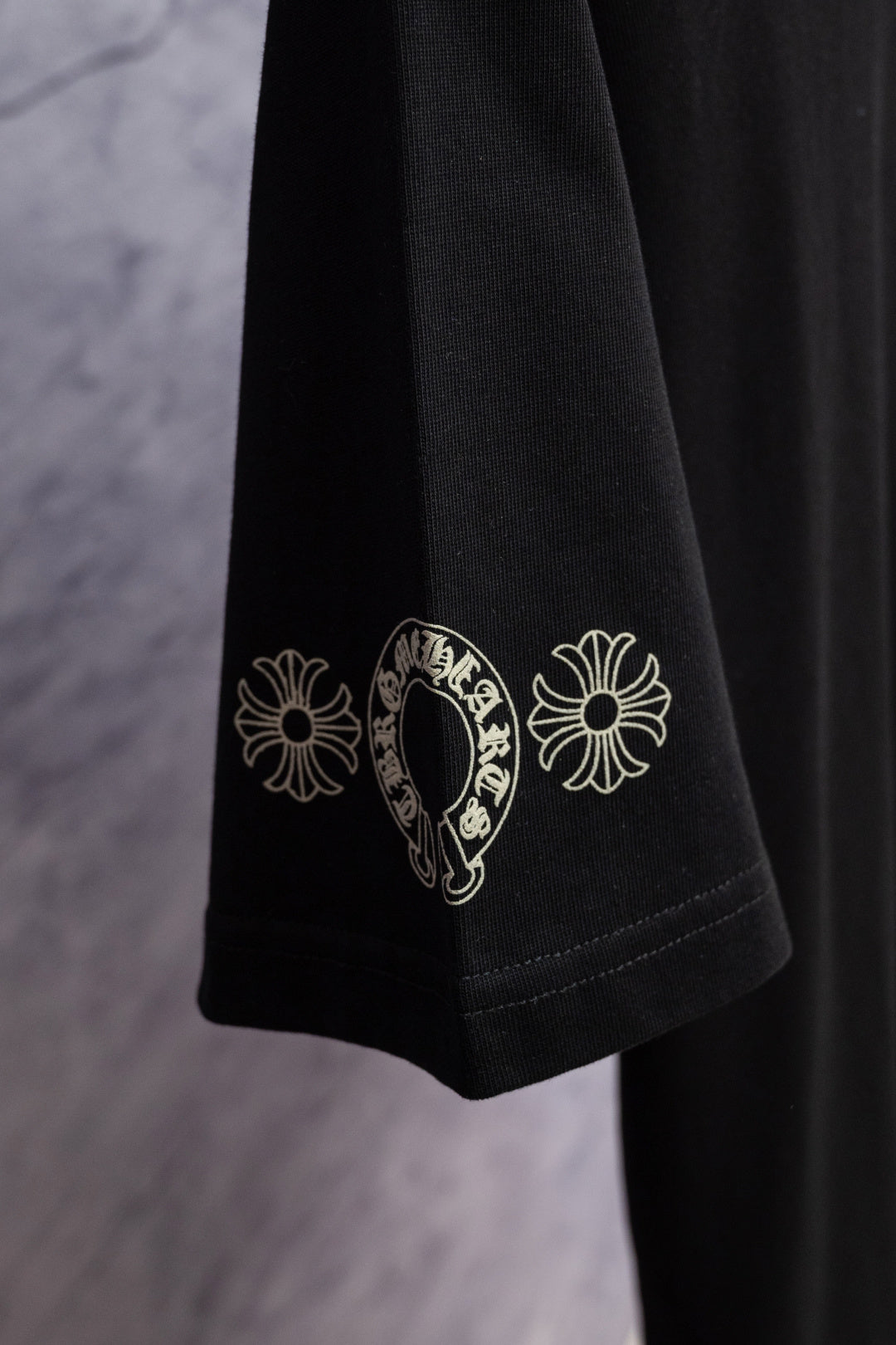 Black T-shirt sleeve with white floral graphic print