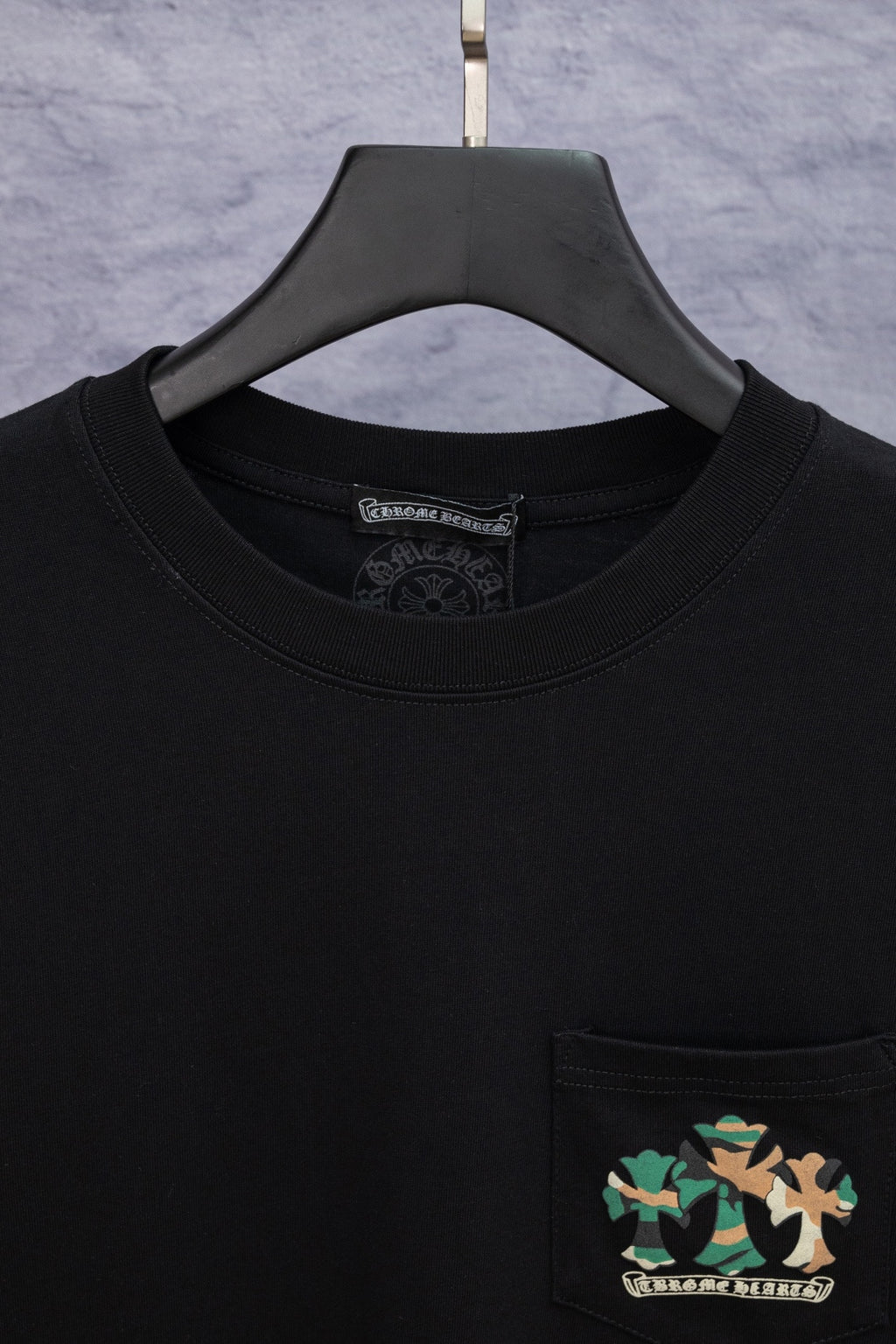 Black crewneck T-shirt with front pocket and chest logo patch