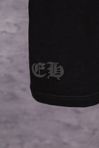Black T-shirt with small dark logo print at side hem