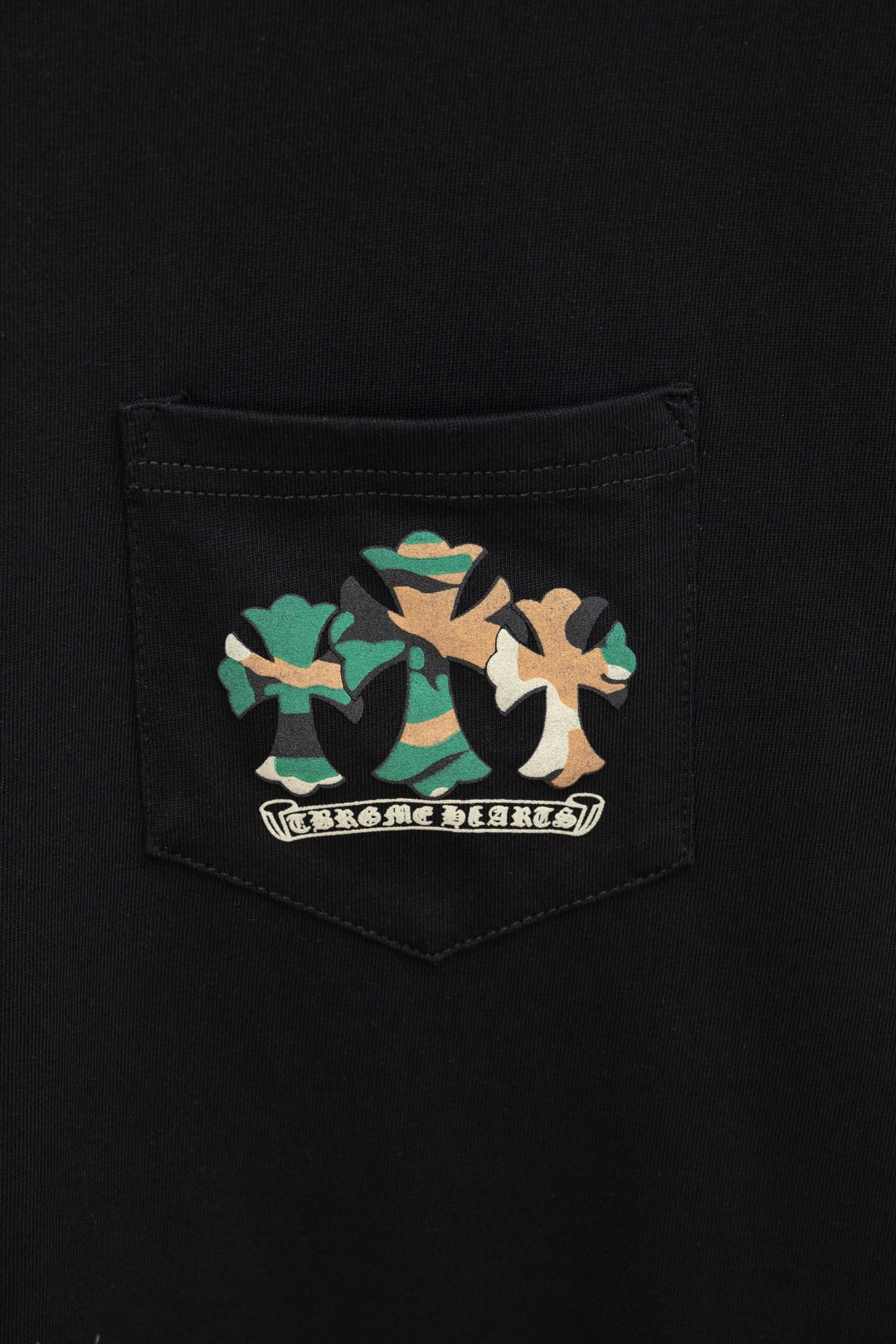 Black T-shirt pocket with colorful emblem graphic patch