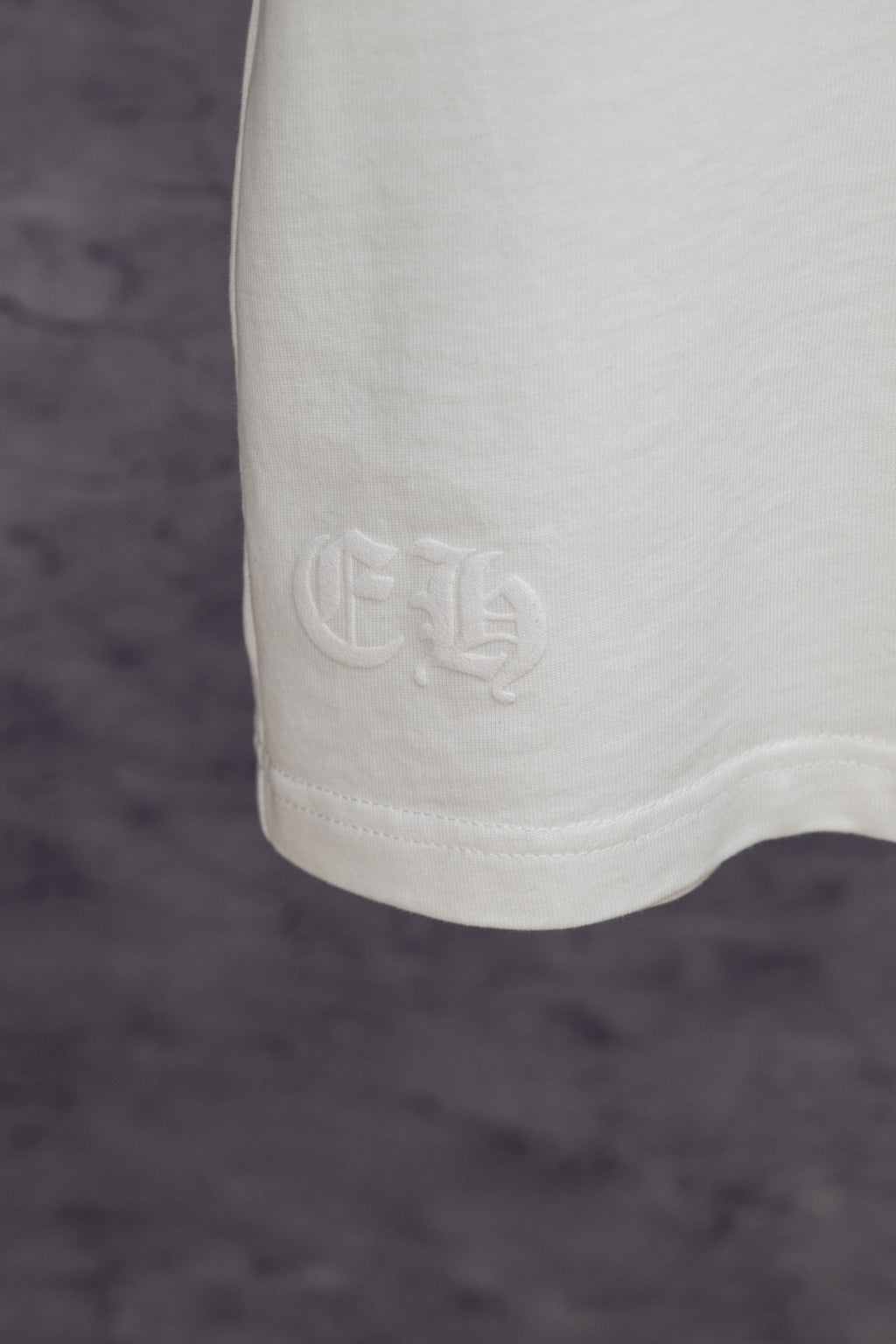 White T-shirt hem with embossed logo detail