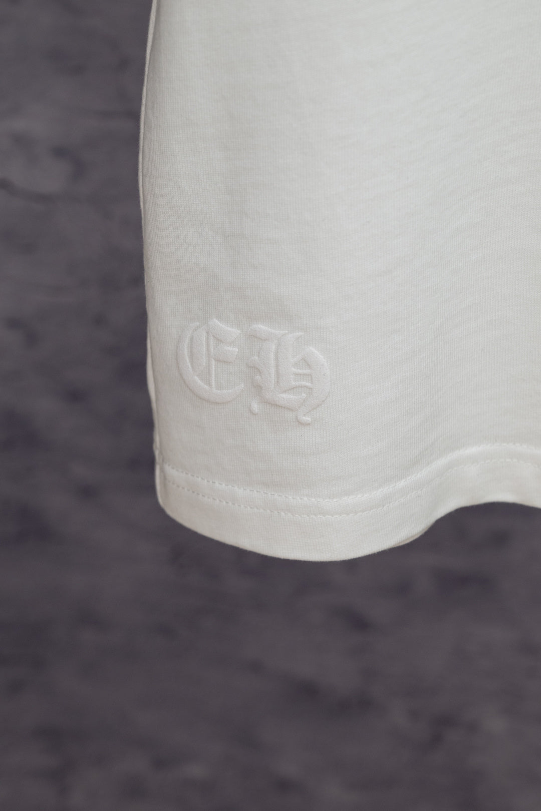 White T-shirt hem with embossed logo detail