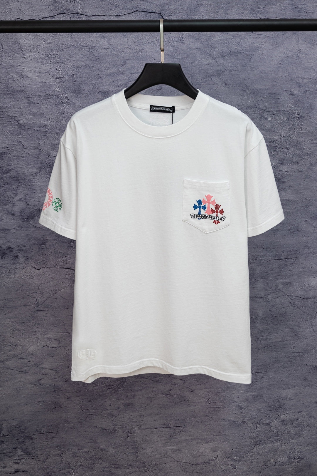 White short-sleeve T-shirt with small left-chest graphic patch