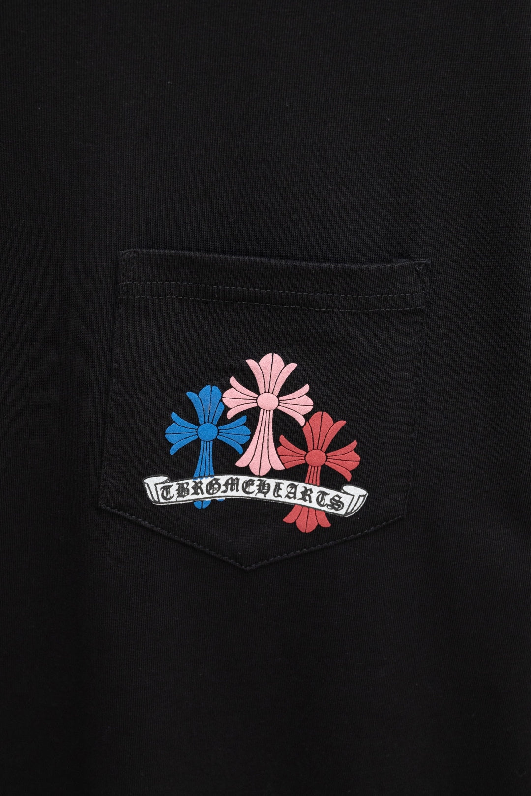 Black T-shirt chest pocket with multicolor emblem patch