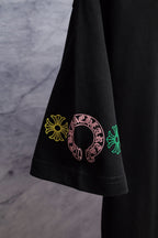 Black T-shirt side with small multicolor crest near the hem