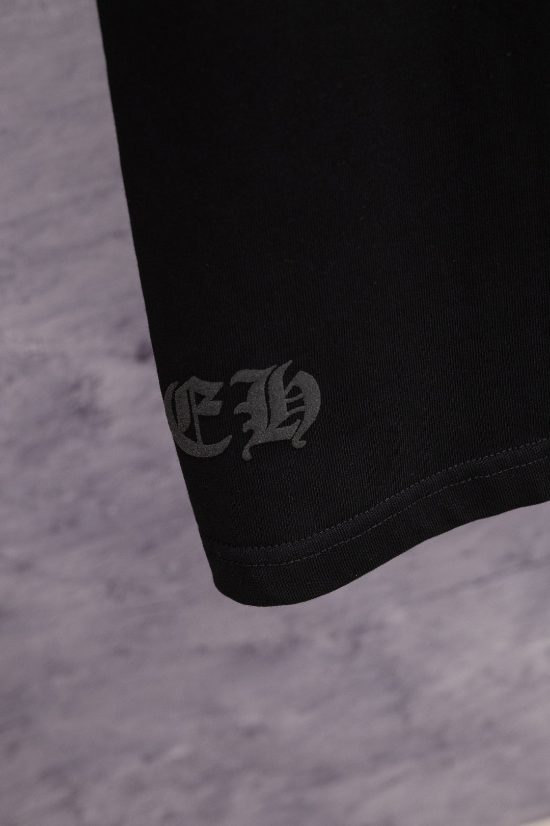 Black T-shirt with dark embroidered hem logo