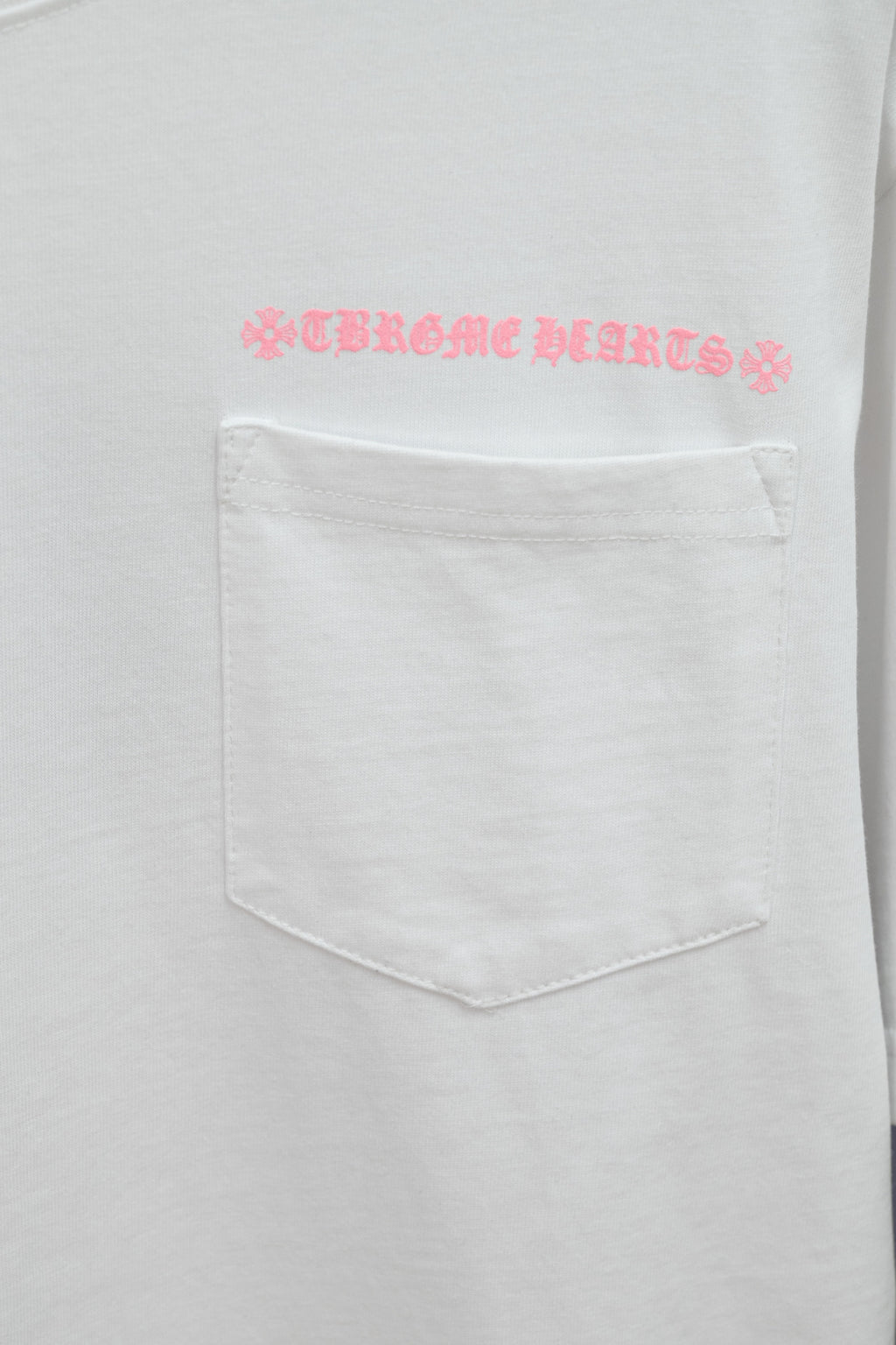 White short-sleeve T-shirt with embroidered pink logo above chest pocket
