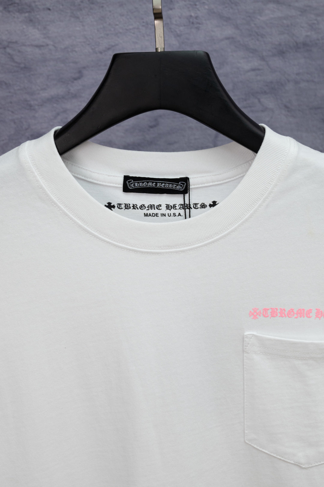 White short-sleeve T-shirt neckline with printed brand label and tag