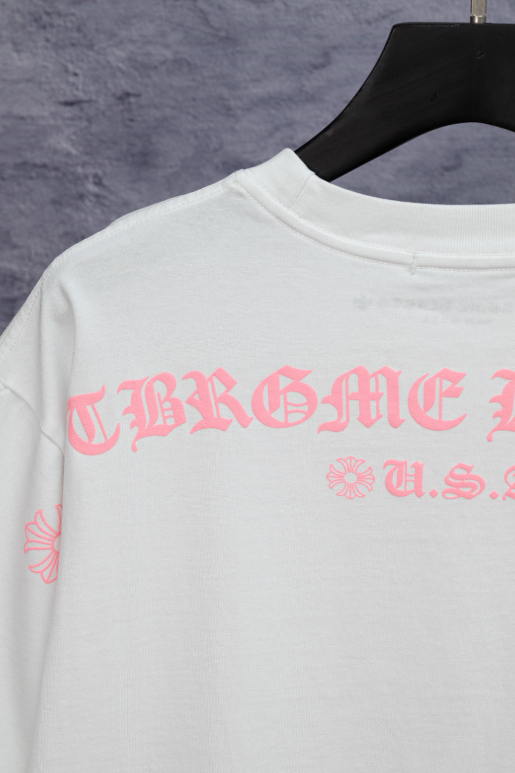 White short-sleeve T-shirt with pink graphic print across back