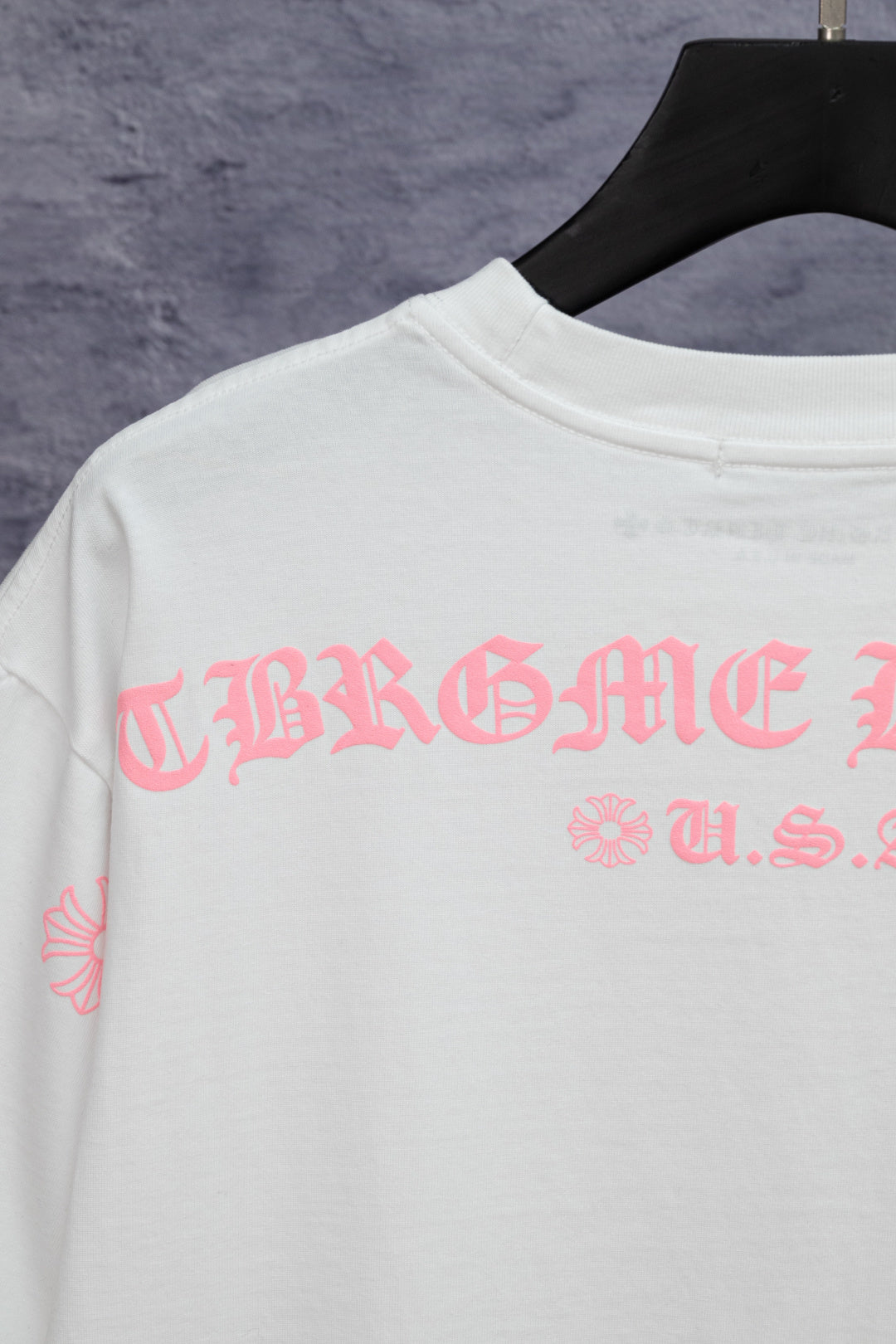 White short-sleeve T-shirt with pink graphic print across back