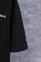 Black short-sleeve T-shirt with small Chrome Hearts logo patch on sleeve hem