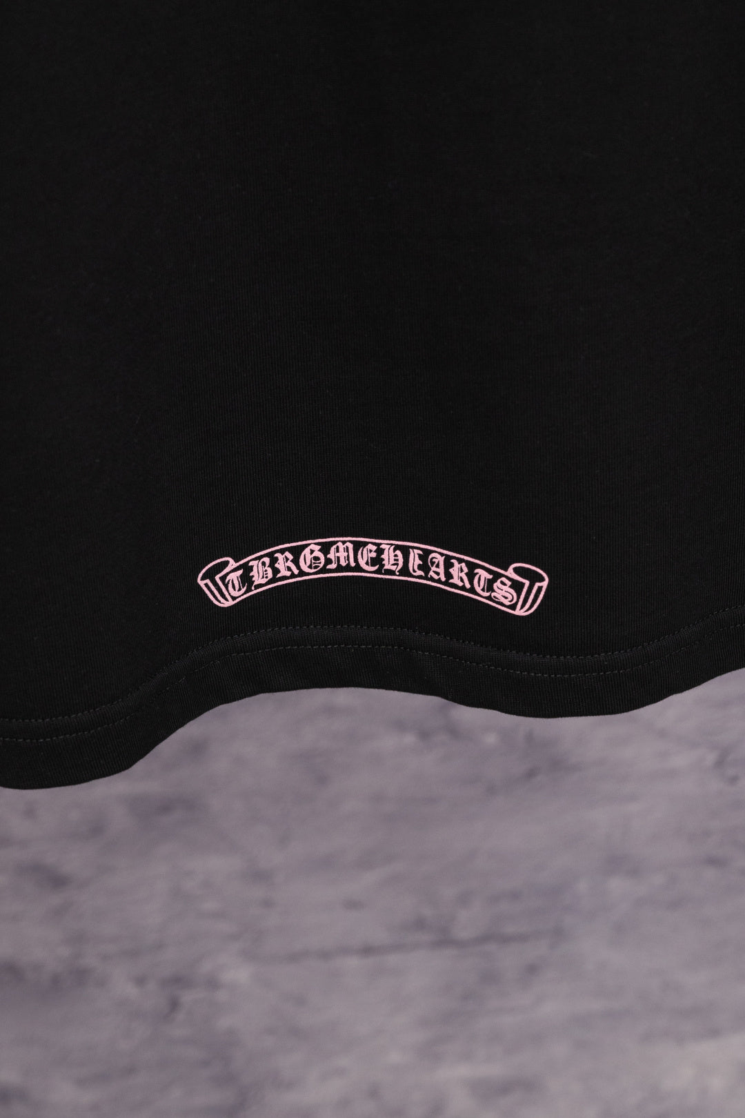 Black short-sleeve T-shirt with small Chrome Hearts oval logo at hem