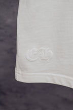 White T-shirt lower hem with small embossed logo detail