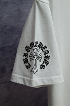 White T-shirt with black floral cross graphic on sleeve