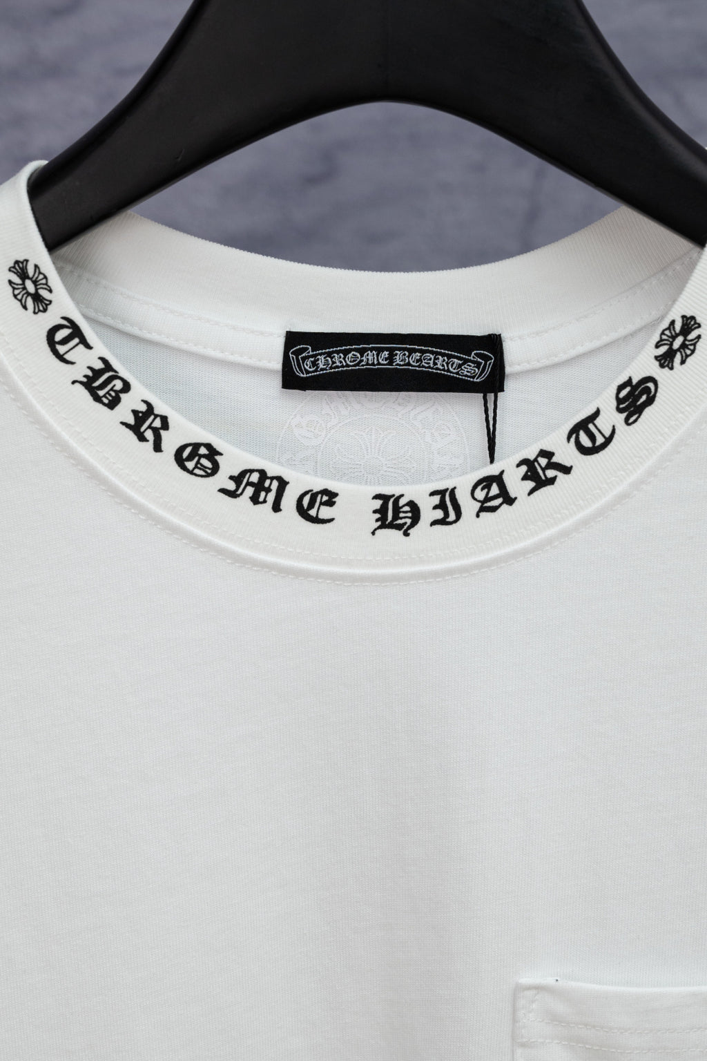 White T-shirt crew neckline with black printed logo text label