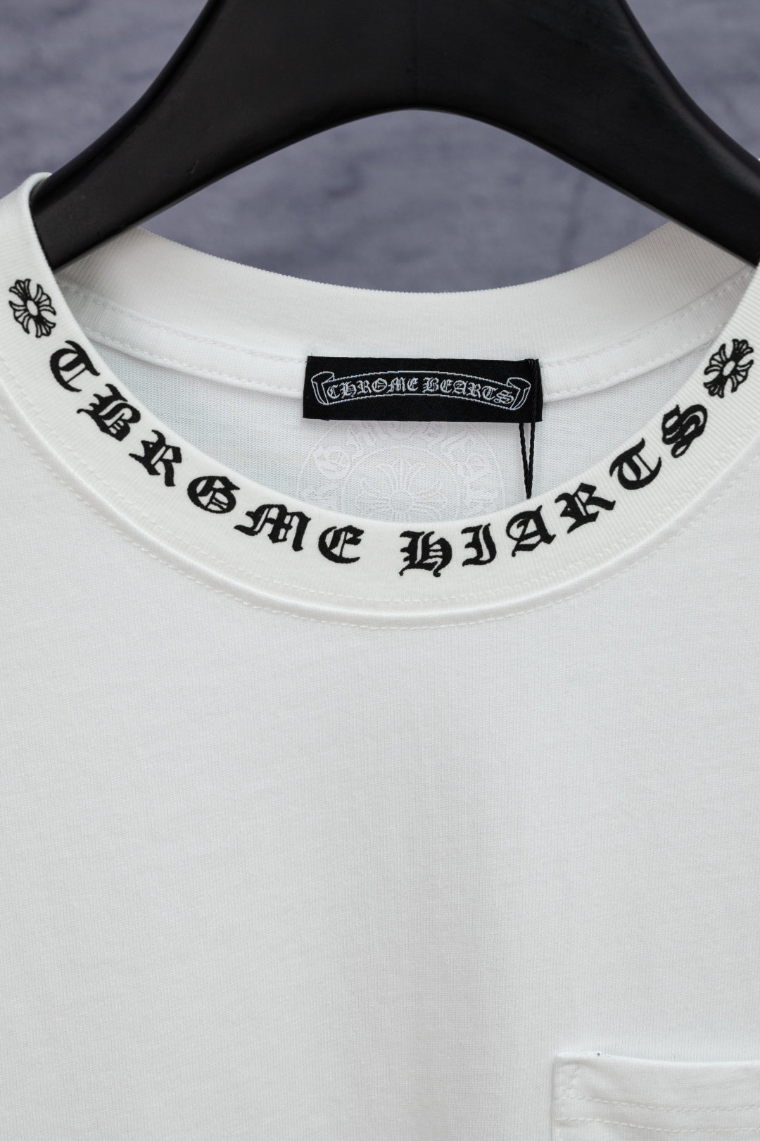 White T-shirt crew neckline with black printed logo text label