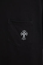Black T-shirt chest pocket with small white cross emblem print