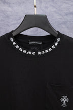 Black T-shirt neckline with printed logo and small chest pocket detail