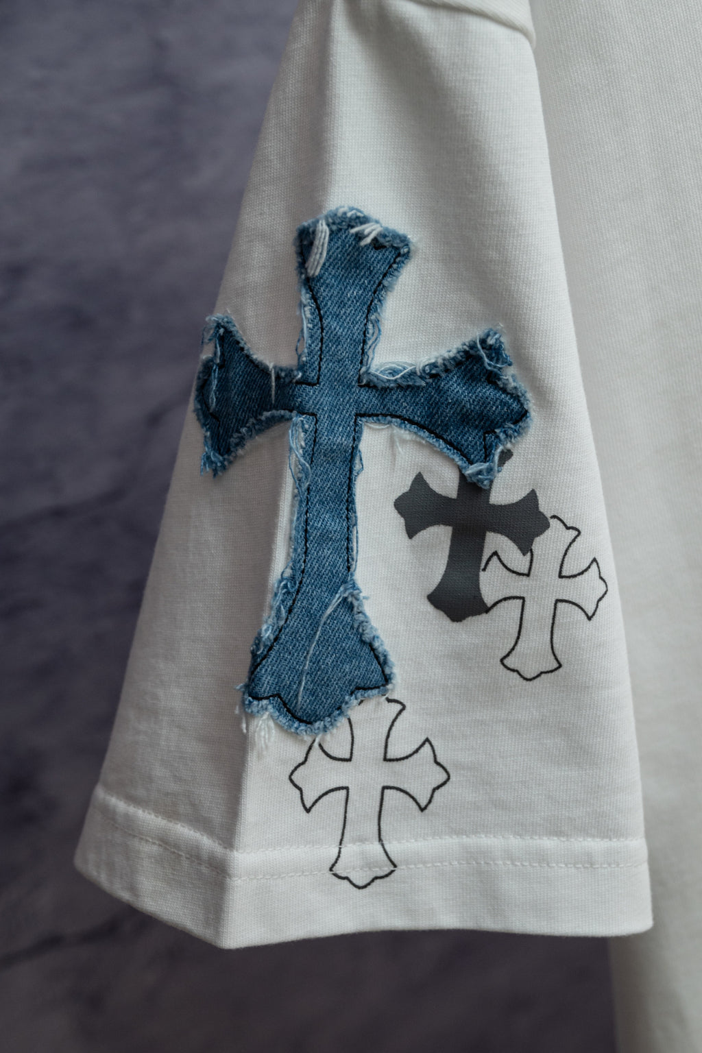White short-sleeve T-shirt with large blue cross applique on front panel