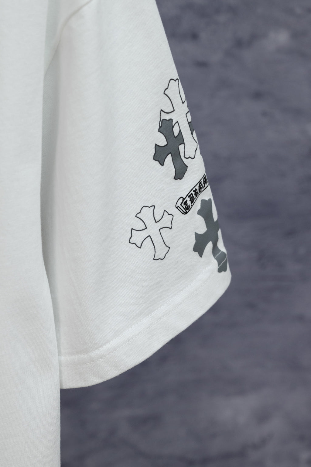 White short-sleeve T-shirt with blue cross patches on sleeve
