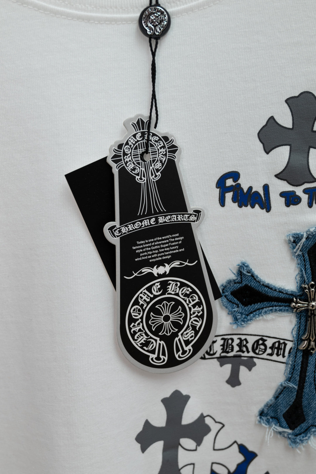 White short-sleeve T-shirt with hang tag and blue cross chest graphic