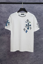 White short-sleeve T-shirt with large blue cross graphic and small dark cross icons